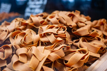 Wall Mural - Italian food, dried handmade colorful pasta pappardelle with saffron, ready to cook, Milan, Lombardy, Italy