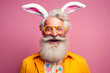 Cheerful senior man with bunny ears and funky glasses, concept of joyful Easter holiday fun