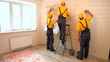 © DenisProduction.com - Specialists wallpapering in the house. Brigade of craftsmen making renovation.