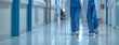© Thitiporn - Healthcare Professionals Walking Through Hospital Corridor