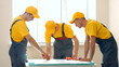 © DenisProduction.com - Large construction company discusses the project. Engineers look project.