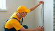 © DenisProduction.com - The engineer makes markings on the wall. Construction work.