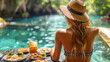 A woman enjoys her luxury vacation with food and drinks by the pool