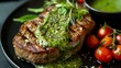 Grilled steak with pesto sauce and cherry tomatoes on black background