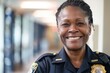 Smiling portrait of a middle aged female police office in station