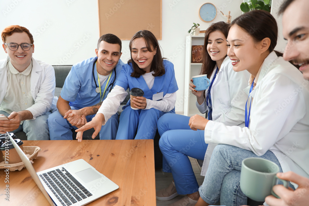 Team of doctors drinking coffee in hospital lounge