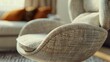 A macro image of a contemporary lounge chair, featuring organic curves, premium fabric upholstery, and a swivel base, inviting relaxation and comfort in a modern home.
