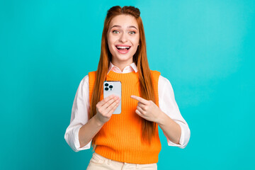 Wall Mural - Photo of surprised amazed pretty girl wear trendy orange clothes wow offer modern technology isolated on cyan color background