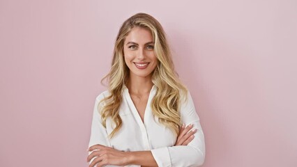 Poster - Young blonde woman wearing shirt standing happy face smiling with crossed arms looking at the camera. positive person. over isolated pink background