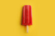 © ADDICTIVE STOCK - Vibrant Red Popsicle on Yellow Background. Generative AI image