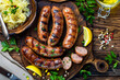Grilled Bratwurst meat sausages with herbs and spices. German cuisine.
