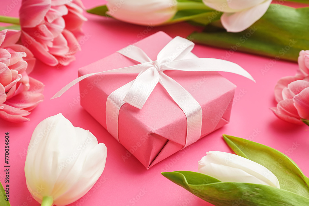 Gift box and beautiful tulips on pink background