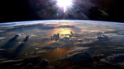 Wall Mural -  A photo of Earth from space, with the sun rising above the horizon and clouds in both the foreground and background