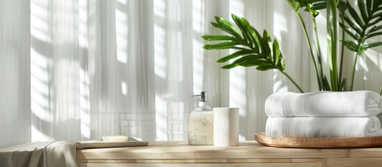 Wall Mural - Bath towels, wooden poster, and houseplant arranged on a table with space for text.