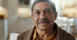 © peopleimages.com - Happy, face and senior man in retirement, home and relax in living room with peace, freedom and wellness. Elderly, portrait and person with happiness or smile in nursing home, living room or house
