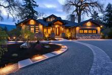 Craftsman House In The Evening, With A Winding Gravel Driveway And Soft Landscape Lighting