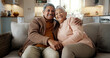 © peopleimages.com - Senior couple, face and hug on couch, smile and bonding with love, support and relax in retirement in home. Elderly woman, old man and portrait with embrace, together and sitting on living room sofa