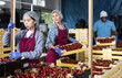 Chinese woman worker controlling quality of cherry in boxes. High quality photo
