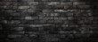 Detailed view of a textured brick wall set against a dark background, showcasing the rugged surface and patterns
