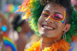 Transgender person in gay pride parade, young Latino with makeup and feather boas in the crowded streets in celebration