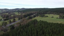 Aerial 4K Drone Shot Of A Pine Tree Plantation Approaching A Rural Private Property And A Country Road In Australia