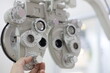 close up of a hand using Phoropter eye exam in hospital 