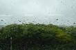 梅雨　雨の滴のついた窓ガラスの奥の山の風景　6月・梅雨明け・水滴