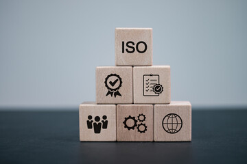 Wall Mural - ISO standards quality control, assurance warranty business, Businesses that pass quality control standards. ISO icon on wooden blocks.