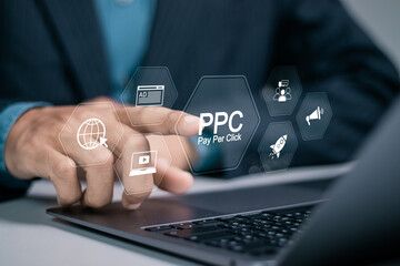 Pay per click PPC concept. Advertising in Search Engine Platforms. Digital Marketing Strategies and Goals. Businessman using laptop with PPC icon on virtual screen.