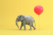 A grey elephant is walking past a red balloon