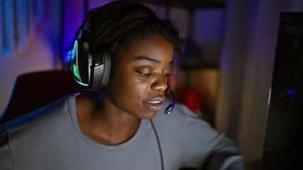 Sticker - Confident young black woman, rocking dreadlocks and a natural smile, fully immersed in her gaming universe, profile view in a dimly lit gaming room