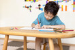 © Blue Jean Images - Cute boy drawing in classroom