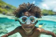 Child with diving mask in clear waters.
