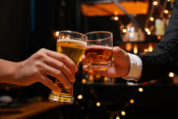 food and drink male friends are happy drinking beer and clinking glasses at a bar or pub.