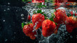 A bunch of ripe strawberries with water droplets falling on black background