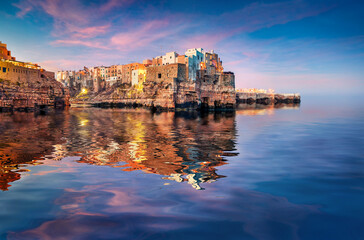 Wall Mural - belvedere terrazza santo stefano in polignano a mare town reflected in the calm waters of adriatic s