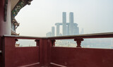Fototapeta Sawanna - Chongqing Thousand Buddha Temple and Raffles City are in the same frame. City foggy scene.