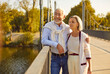 © Studio Romantic - Senior couple during leisurely stroll in a charming city park. This portrait conveying the happiness of vacation and holiday, as the couple shares smiles while immersed in the beauty of nature.