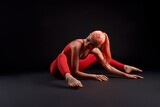 Fototapeta  - Athlete woman stretching on the floor with her legs apart