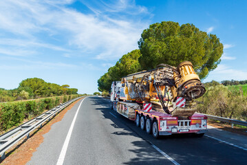 Canvas Print - Truck for bulky and special transport circulating with a drilling machine, rear view.