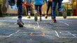 Playing a traditional jump game with chalk markings on a hard surface, symbolizing childhood innocence and enjoyment during school breaks.
