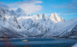 Jagged snowcapped mountains along a fjord on Lofoten islands, northern Norway