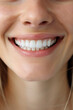 A close-up of a woman's smile with beautiful, straight, white teeth