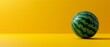   An egg-shaped watermelon with a green leafy pattern on a yellow background