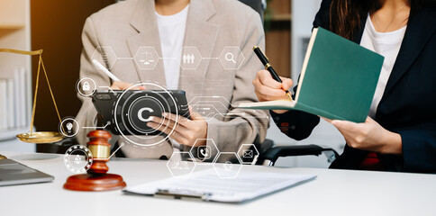 Wall Mural - Copyright or patent concept, Business team analyzing data and using smart phone and tablet with virtual screen copyright icon trademark license, Creation ownership against piracy.