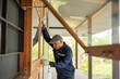 © Chanakon - Technician worker in uniform using measuring tape tool to measuring wood window in the home construction site. repair and fix for problem in the house