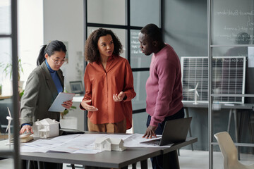 Aufkleber - Young confident African American female architect looking at male colleague while discussing points of new business project