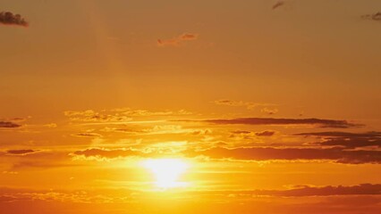 Wall Mural - A time lapse of the sunrise reveals the changing colors of the sky, from bright orange to soft yellow, time lapse.