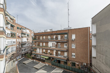 Wall Mural - Interior patio of a block of urban residential homes with balconies and terraces.