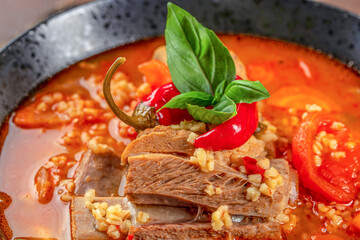Wall Mural - vegetable soup with bulgur, tomatoes and ribs. Food recipe background. Close up